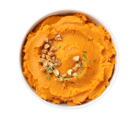 Delicious mashed sweet potatoes and walnuts in bowl isolated on white, top view