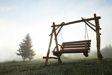 Wooden swing outdoors in morning, low angle view