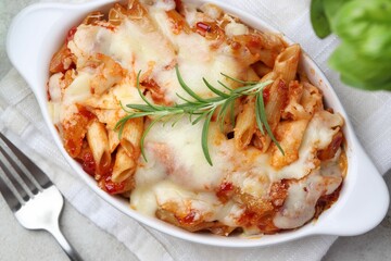 Delicious al forno pasta in baking dish on light table, top view