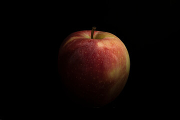 Red apple on a black background. Isolated on black background