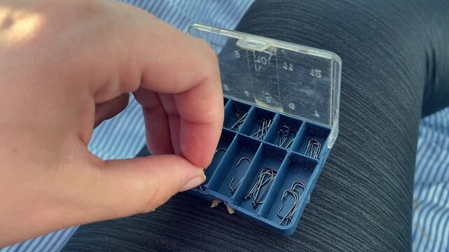 Man picks up a fishing hook