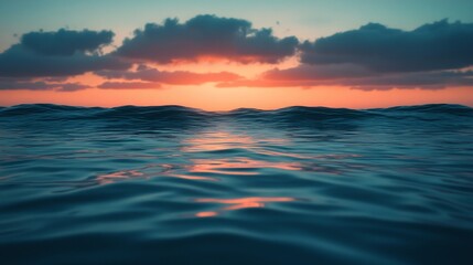 Obraz premium The ocean is calm and the sky is a beautiful orange color