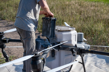 Operator replacing battery of agricultural drone.