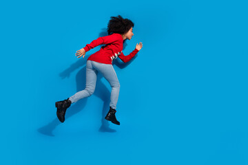 Photo of positive funny woman wear red stylish clothes go fast hurry christmas sale offer isolated on blue color background