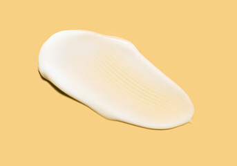 Face or body white balm milk emulsion cream hair balm yellow mango colored background
