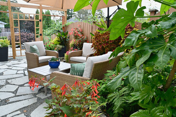Outdoor tropical terraced patio in backyard garden for casual outdoor seating