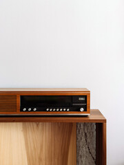 Fototapeta premium A vintage wooden radio placed in a bright room with minimalist design
