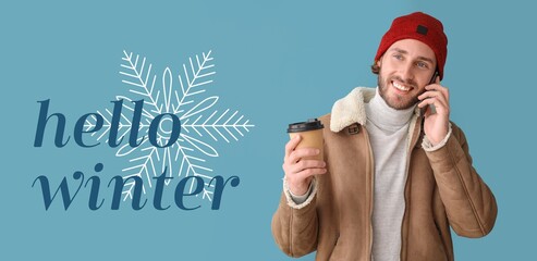 Handsome man with coffee talking by mobile phone on blue background. Hello, winter