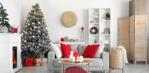 Interior of living room with sofa, fireplace and burning candles