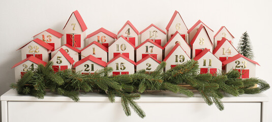 Advent calendar with Christmas branches on drawers in room