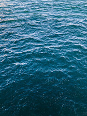 seascape of choppy waves in deep blue sea with bubbles