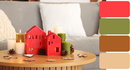 Burning candles with house shaped holders and Christmas decor on table in living room. Different color patterns