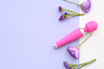 Pink vibrator from sex shop and beautiful flowers on color background
