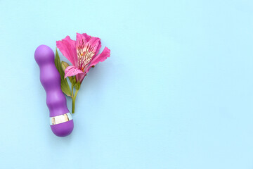 Beautiful alstroemeria flower and vibrator on blue background