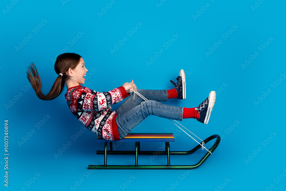 Sticker Photo of lovely pretty cute girl dressed red clothes enjoy christmas time sliding sled isolated on blue color background