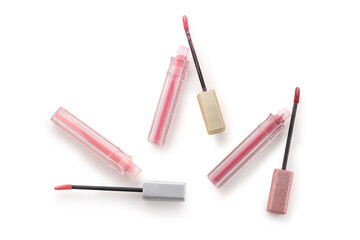 Beautiful liquid pink lipsticks in different shades on white background