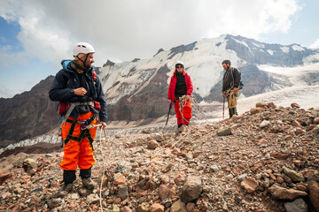 A group of hikers navigates the glacier-covered landscape of Mount Kazbegi