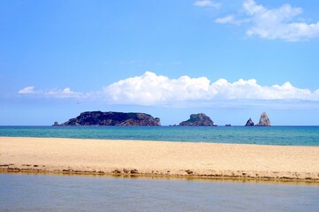 Illes Medes rocky island in the Mediterranean Sea near l'Estarit seen from the beach, a sand bank at La Gola del Ter in the foreground, Catalonia, Costa Brava, Girona, Spain