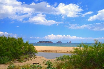 Illes Medes rocky island in the Mediterranean Sea near l'Estarit seen from the beach with dunes and sand bank at La Gola del Ter, Catalonia, Costa Brava, Girona, Spain