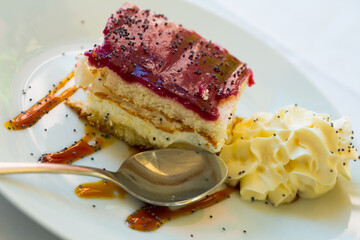 Image of piece of blueberry cake served with whipped cream