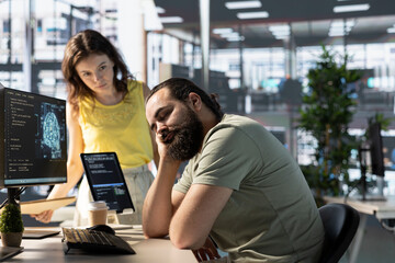 Programmer caught asleep at desk by manager while developing AI machine learning APIs solving complex problems. Tired sleeping man woken up by team leader while training predictive models