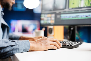 African american freelancer working on movie montage project, creating new white balance and...