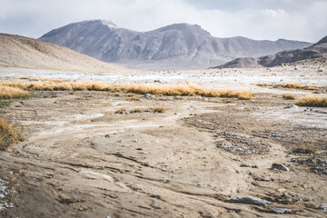 Panoramic landscape of textured Tien Shan mountains in Pamir in Tajikistan, panoramic landscape of a mountain range with snow and glaciers in summer