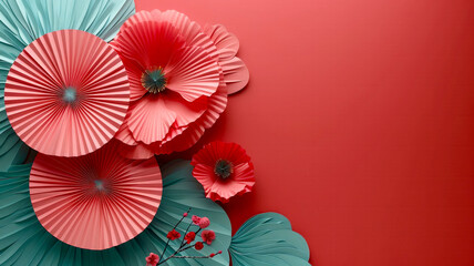 Obraz premium A vibrant display of handmade paper flowers in shades of pink and turquoise is beautifully arranged on a bright red background, creating a stunning visual effect perfect for festive occasions.