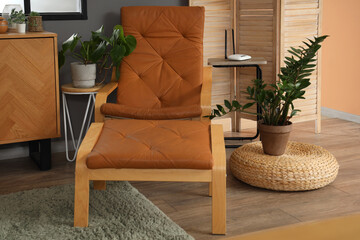 Interior of modern living room with armchair and wi-fi router on table