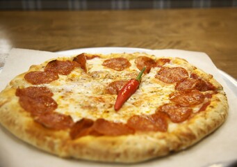 pizza with ham, red pepper and cheese