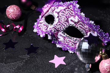 Lilac carnival mask with Christmas decor on black background