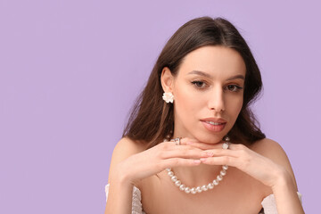 Woman wearing jewelry on purple background