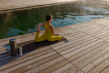 Experience a Serene and Refreshing Yoga Session by the Poolside While Dressed in Yellow Activewear