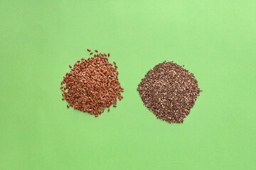 Organic chia and flax seeds in two piles - Linum usitatissimum and Salvia hispanica.