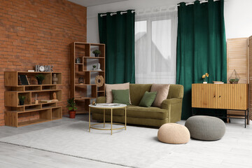 Stylish interior of living room with sofa near brick wall