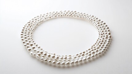 Obraz premium A mesmerizing trail of pearls forming a perfect circular pattern on a white backdrop, symbolizing grace and luxury