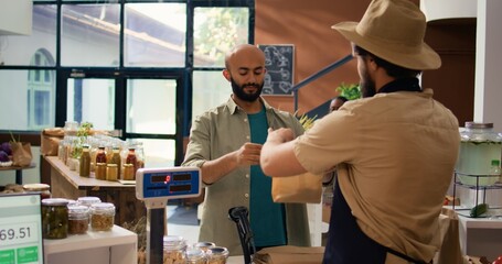 Adding pasta in paper bag to buy enough for nutritious dinner, choosing natural bio pantry supplies...