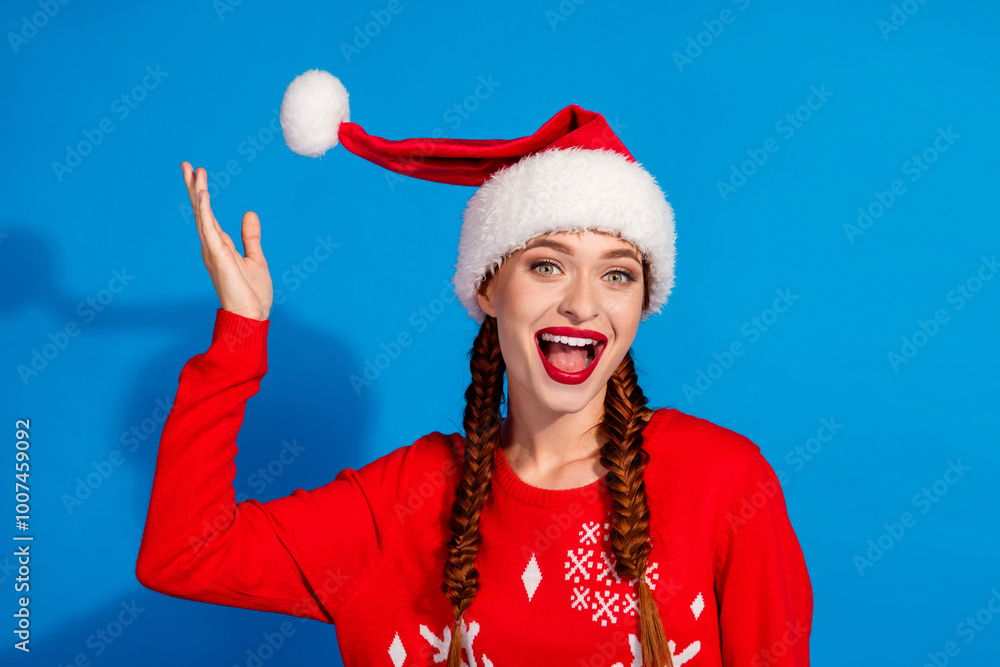 Sticker Photo of attractive young woman play hat pompom excited dressed red christmas clothes theme party on blue color background