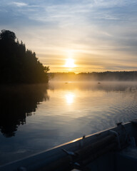 sunrise on boat in lake
