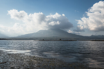 Silhouette of a volcano on the other side of a large lake