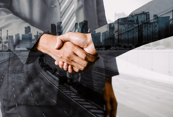 Double exposure image of business people handshake on city office building in background show...