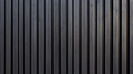 Obraz premium Corrugated black metal texture. Steel roof sheet. Siding panels for the wall. Iron building material for fence. Surface of a cargo container. 