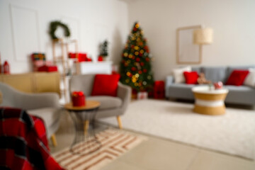 Blurred view of living room with sofa, armchairs and Christmas trees