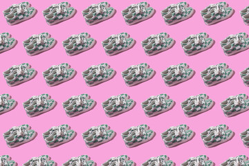 Pattern of modern white leather sneakers with green checkered and lines with hard shadow on pink background. Fashion, modern, eye-catching, quirky and fun concept.