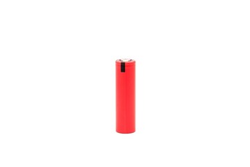18650 battery isolated on white background. Red battery standing on its end.