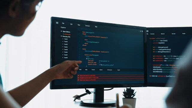 Back end software developer engineer for computer programming working together on debugging writing computing code, solving complex algorithms display on monitor in office. Burgeoning