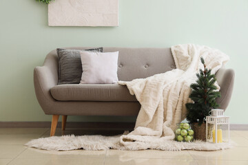 Christmas tree with lantern and sofa in living room