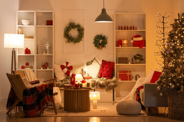 Interior of dark living room with glowing lamps, Christmas tree and sofa