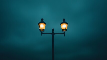 Two vintage street lamps glowing softly against a deep blue evening sky