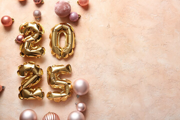 Figure 2025 made of foil balloons with Christmas balls on beige background
